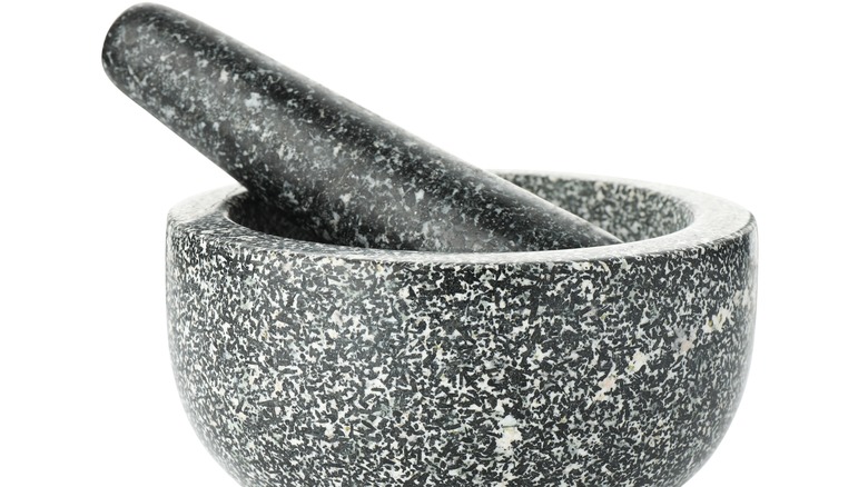 Stone mortar and pestle on a white background